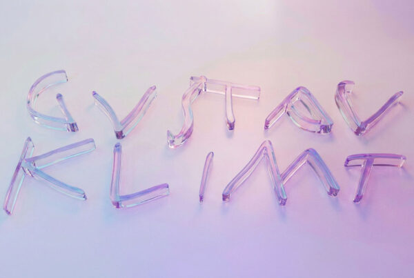 Transparent glass letters spelling a two-word phrase on a soft pink–purple gradient background.