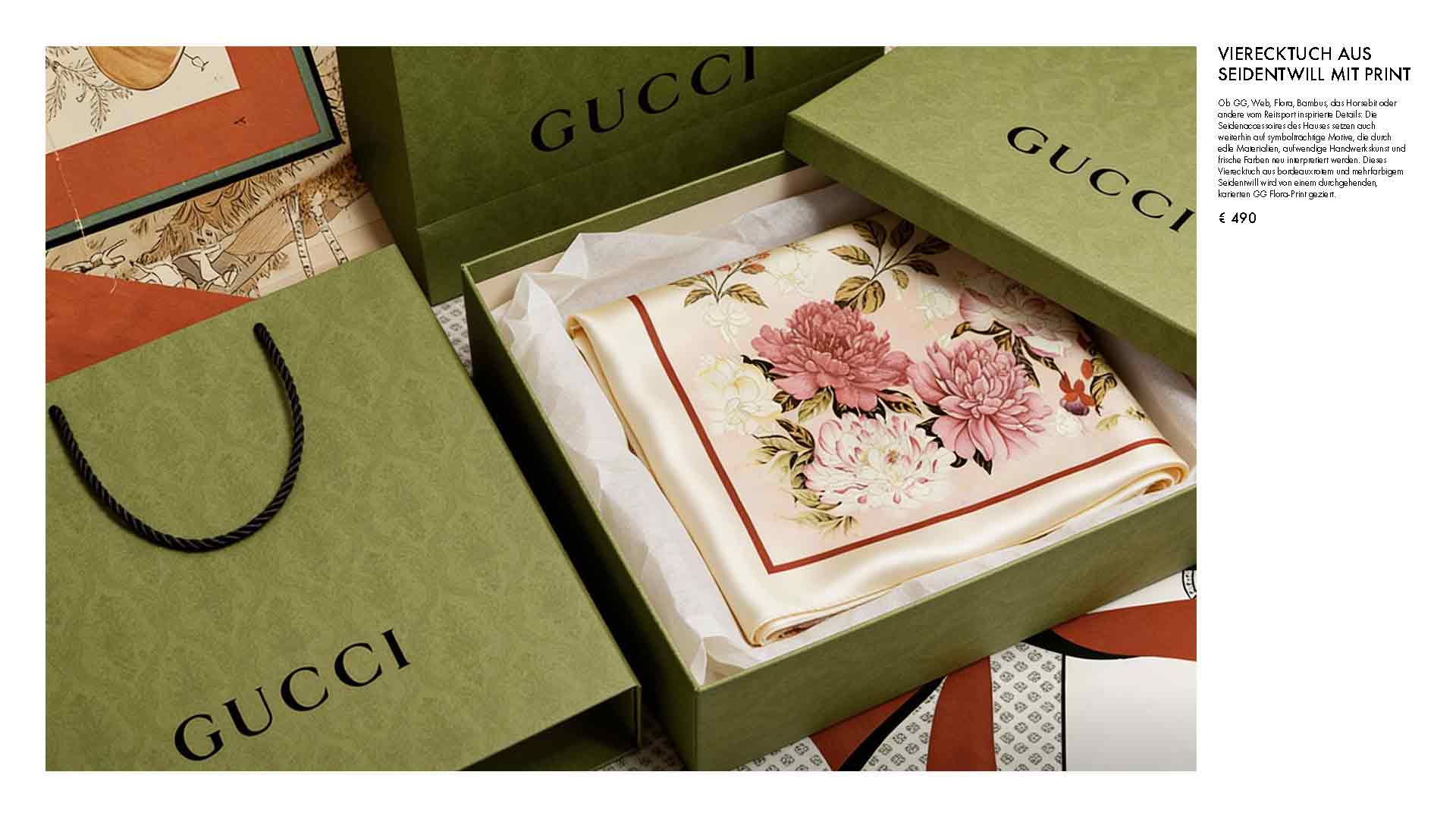 Green Gucci gift boxes with tissue paper and a floral scarf inside; brand name visible on the boxes.
