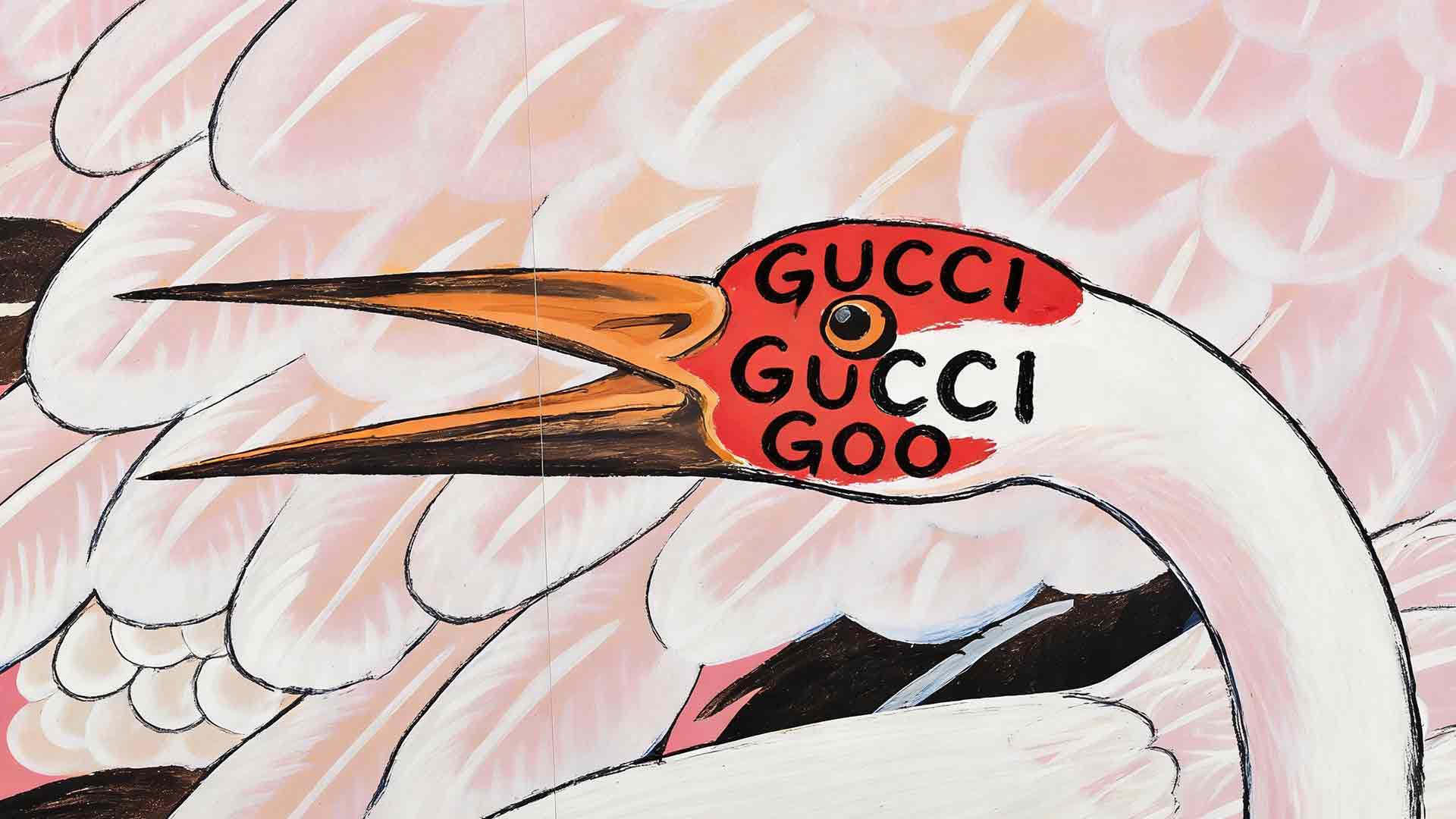 Abstract mural of a white bird with an orange beak, featuring the words 'GUCCI GUCCI GOO' on a red patch near its neck.