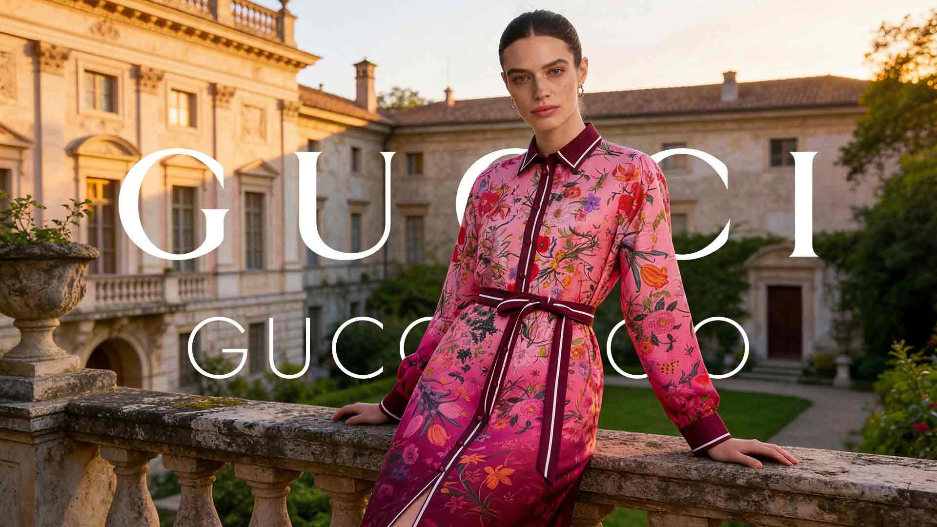 Model wearing a pink floral dress leans on a stone railing in a sunlit historic estate courtyard with Gucci branding overlaid on the scene.
